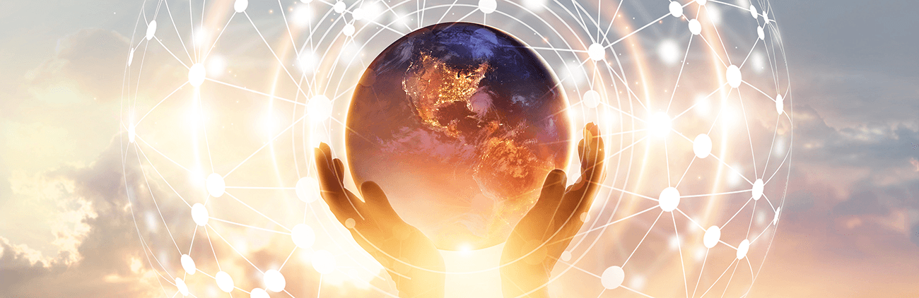 hands holding a globe in the sunset